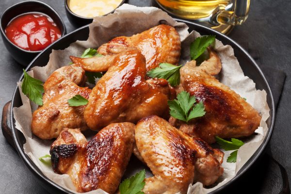 Hot barbecue chicken wings with sauce and draft beer