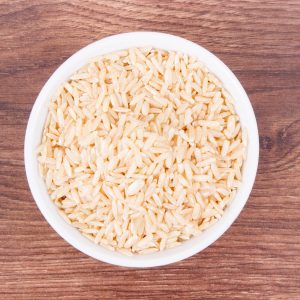 Heap of brown rice in glass bowl